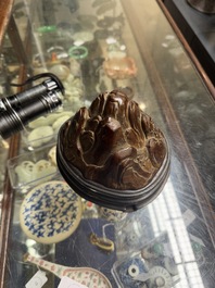 A Chinese agarwood carving of a mountain on wooden stand, 18/19th C.