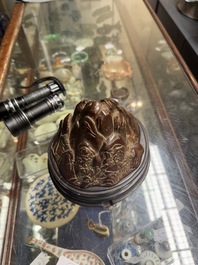 A Chinese agarwood carving of a mountain on wooden stand, 18/19th C.