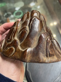 A Chinese agarwood carving of a mountain on wooden stand, 18/19th C.