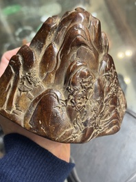 A Chinese agarwood carving of a mountain on wooden stand, 18/19th C.