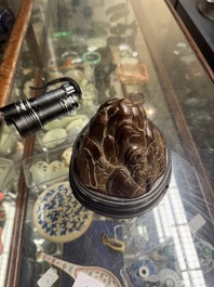 A Chinese agarwood carving of a mountain on wooden stand, 18/19th C.