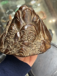 A Chinese agarwood carving of a mountain on wooden stand, 18/19th C.