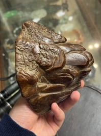 A Chinese agarwood carving of a mountain on wooden stand, 18/19th C.