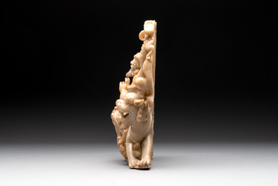 A Chinese carved group of a Luohan with two tigers, 20th C.