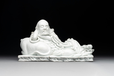 A Chinese Dehua blanc de Chine figure of a Luohan reclining on a tiger, Dehua and Bo Ji Yu Ren 博及漁人 mark, 20th C.