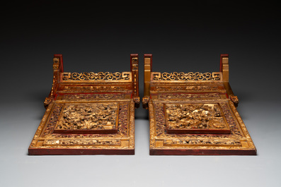 A pair of Chinese gilt-lacquered openworked wooden table screens with warriors on horseback, 19th C.