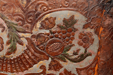 A gold leather fragment with floral design mounted on a wooden panel, Mechelen, 18th C.