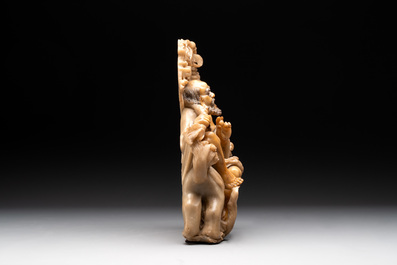 A Chinese carved group of a Luohan with two tigers, 20th C.