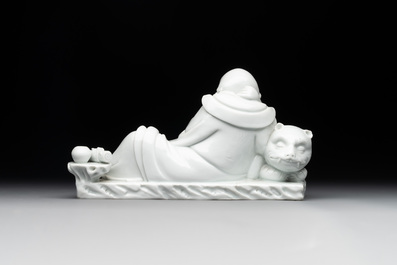 A Chinese Dehua blanc de Chine figure of a Luohan reclining on a tiger, Dehua and Bo Ji Yu Ren 博及漁人 mark, 20th C.