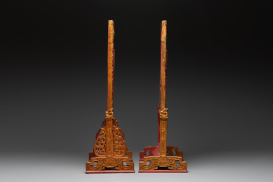A pair of Chinese gilt-lacquered openworked wooden table screens with warriors on horseback, 19th C.
