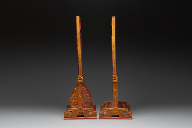 A pair of Chinese gilt-lacquered openworked wooden table screens with warriors on horseback, 19th C.