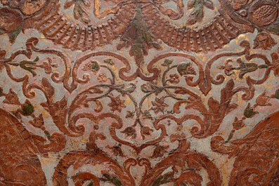 A gold leather fragment with floral design mounted on a wooden panel, Mechelen, 18th C.