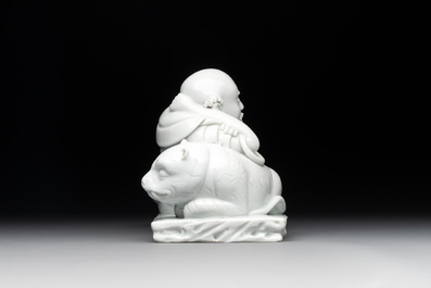 A Chinese Dehua blanc de Chine figure of a Luohan reclining on a tiger, Dehua and Bo Ji Yu Ren 博及漁人 mark, 20th C.