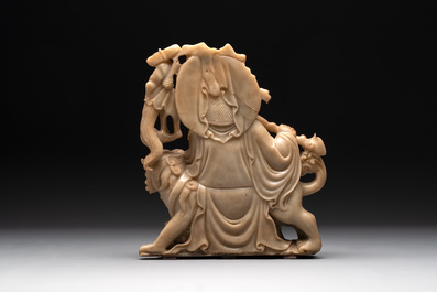 A Chinese carved group of a Luohan with two tigers, 20th C.