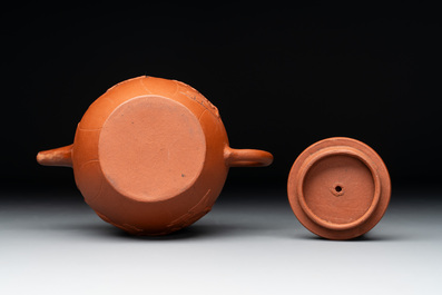 A Chinese Yixing stoneware reticulated double-walled teapot and a teapot with floral relief design, Kangxi