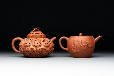 A Chinese Yixing stoneware reticulated double-walled teapot and a teapot with floral relief design, Kangxi