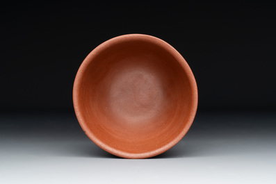 A Chinese Yixing stoneware cup and saucer with plum blossom relief design, Kangxi