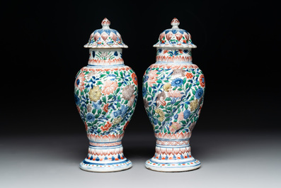 A pair of Chinese famille verte vases and covers with floral design, Kangxi