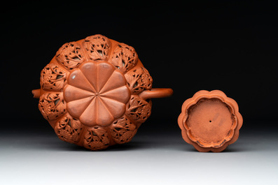 A Chinese Yixing stoneware reticulated double-walled teapot and a teapot with floral relief design, Kangxi