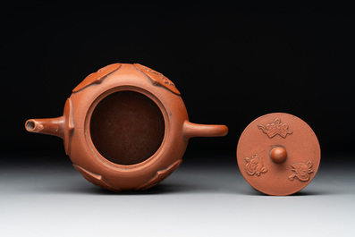 A Chinese Yixing stoneware reticulated double-walled teapot and a teapot with floral relief design, Kangxi