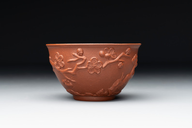 A Chinese Yixing stoneware cup and saucer with plum blossom relief design, Kangxi