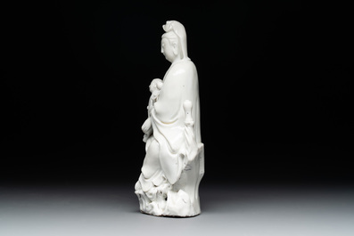 A Chinese Dehua blanc de Chine figure of Guanyin with a boy, Kangxi/Qianlong