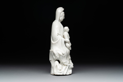 A Chinese Dehua blanc de Chine figure of Guanyin with a boy, Kangxi/Qianlong