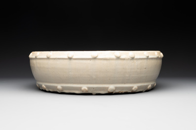 A large Chinese cream-glazed drum-shaped basin, Ming