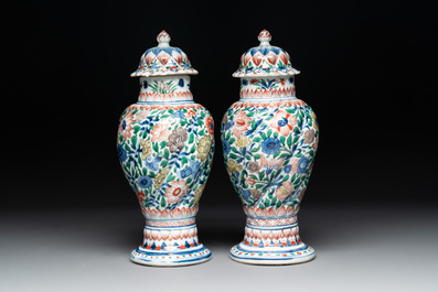 A pair of Chinese famille verte vases and covers with floral design, Kangxi