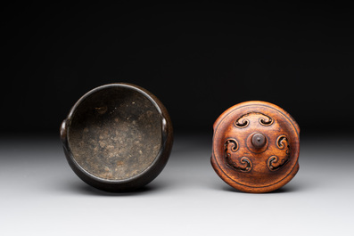 A Chinese bronze tripod censer with wooden cover and stand, Xuande mark, 18/19th C.