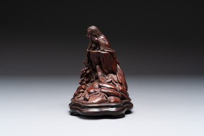 A fine Chinese carved bamboo group with Liuhai on wooden stand, 19th C.