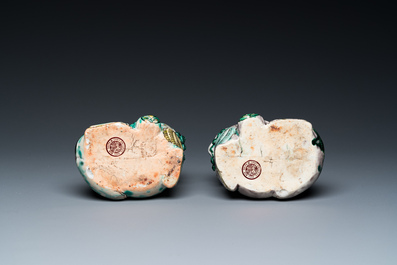 A pair of Chinese verte biscuit vases resting on Buddhist lions, Kangxi