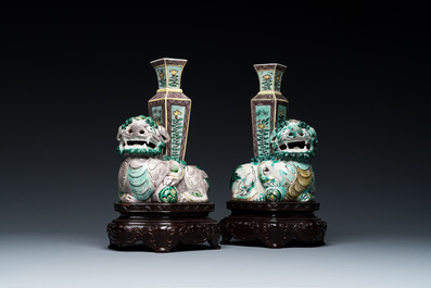 A pair of Chinese verte biscuit vases resting on Buddhist lions, Kangxi