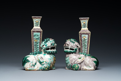 A pair of Chinese verte biscuit vases resting on Buddhist lions, Kangxi
