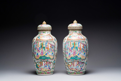 A pair of Chinese Canton famille rose vases and covers with narrative design, 19th C.
