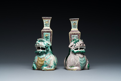 A pair of Chinese verte biscuit vases resting on Buddhist lions, Kangxi