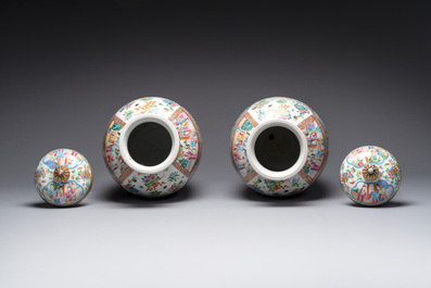 A pair of Chinese Canton famille rose vases and covers with narrative design, 19th C.