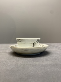 A Chinese grisaille and gilt-decorated 'European subject' cup and saucer, Qianlong