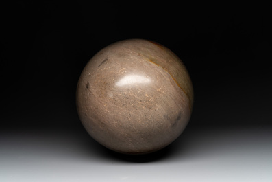 A large Shiva lingam stone on a metal stand