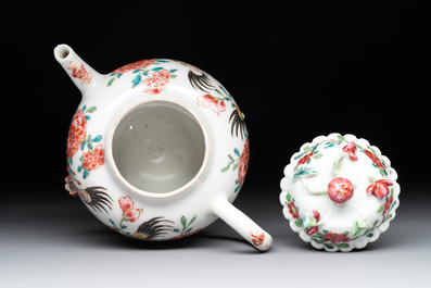 A Chinese famille rose 'rooster' teapot with applied floral design, two cups and a saucer, Yongzheng/Qianlong