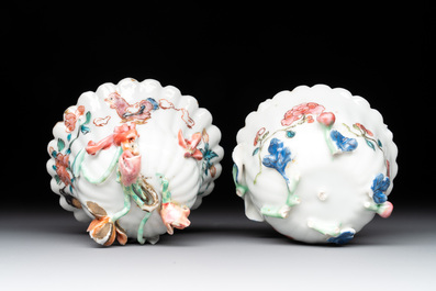 A Chinese famille rose 'rooster' teapot with applied floral design, two cups and a saucer, Yongzheng/Qianlong