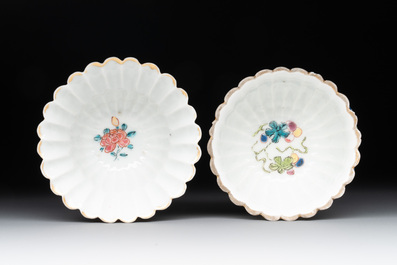 A Chinese famille rose 'rooster' teapot with applied floral design, two cups and a saucer, Yongzheng/Qianlong