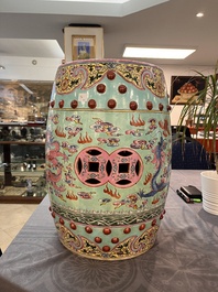 A pair of Chinese famille rose turquoise-ground 'dragon' garden seats, 20th C.