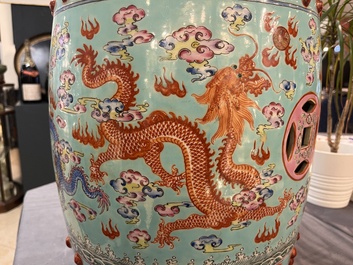 A pair of Chinese famille rose turquoise-ground 'dragon' garden seats, 20th C.
