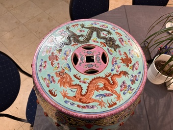 A pair of Chinese famille rose turquoise-ground 'dragon' garden seats, 20th C.
