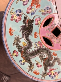 A pair of Chinese famille rose turquoise-ground 'dragon' garden seats, 20th C.