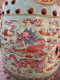 A pair of Chinese famille rose turquoise-ground 'dragon' garden seats, 20th C.