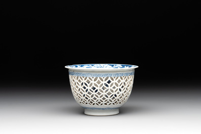 A Chinese blue and white reticulated double-walled cup and saucer, fu mark, Kangxi
