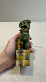 A pair of Chinese sancai-glazed Buddhist lions and an inkwell, 19th C.