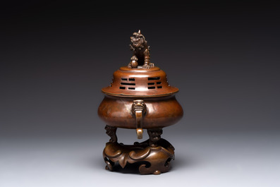 A Chinese bronze tripod censer with cover and stand, a small tripod censer and a silver-inlaid iron brush pot, 19/20th C.